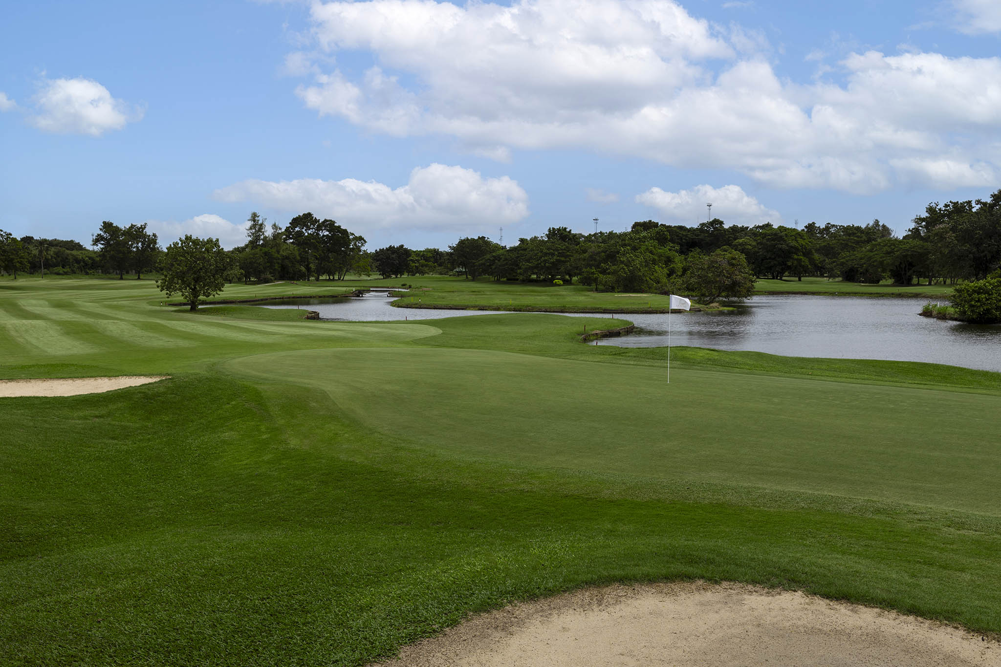 Ekachai-Golf-and-Country-Club-water-view-blue-sky-green-bunker.jpg