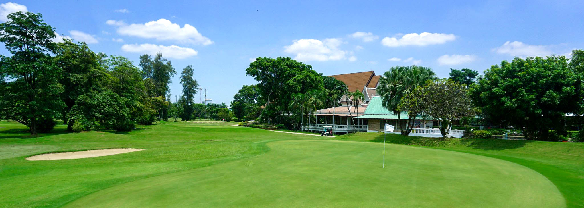 Ekachai-Golf-and-Country-Club-clubhouse-view-blue-sky-green.jpg